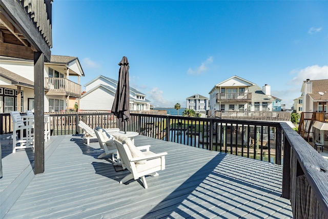 wooden terrace featuring a water view