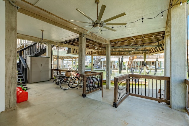 exterior space with a wealth of natural light, ceiling fan, and concrete flooring