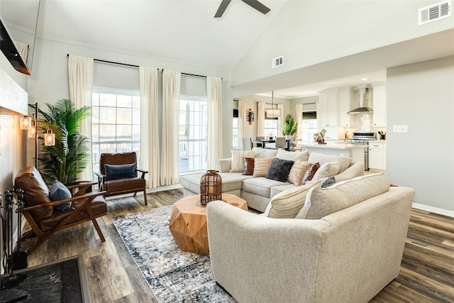 living room featuring ceiling fan, high vaulted ceiling, and dark hardwood / wood-style floors