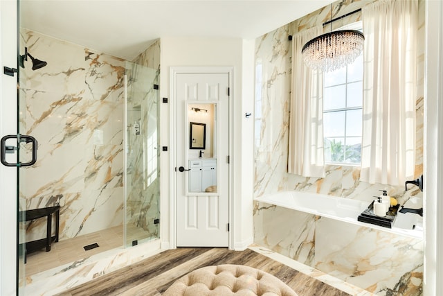 mudroom with hardwood / wood-style flooring and an inviting chandelier