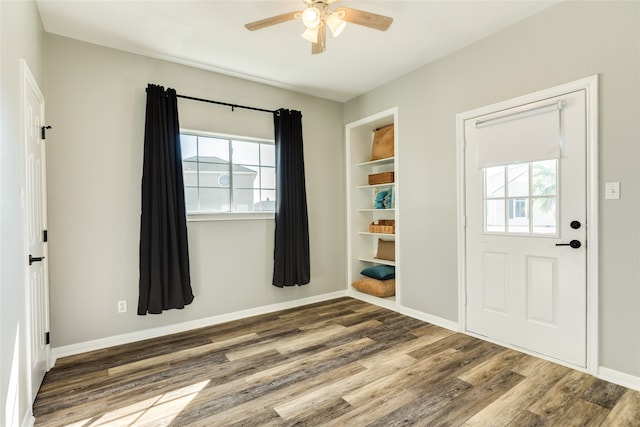 foyer with ceiling fan and dark hardwood / wood-style flooring