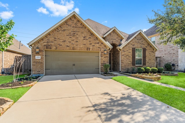 front of property with a garage and a front lawn