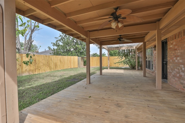 deck with a lawn and ceiling fan