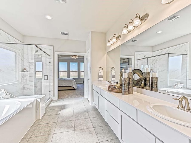 bathroom with plus walk in shower, tile patterned flooring, and vanity