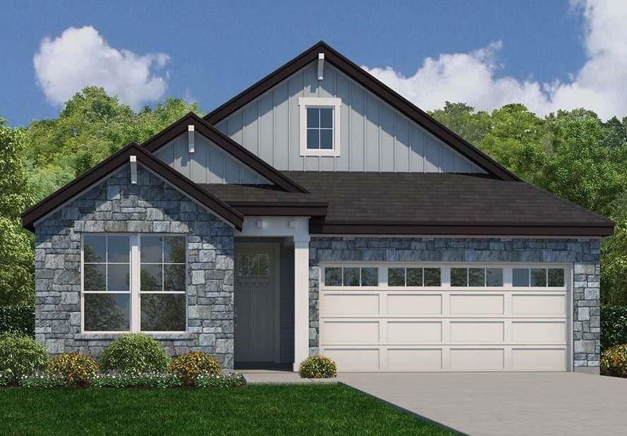 view of front of house featuring an attached garage, concrete driveway, board and batten siding, and stone siding