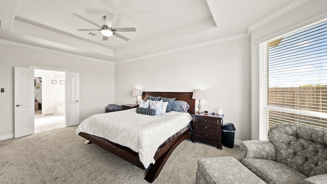 bedroom featuring light carpet, a tray ceiling, ceiling fan, and ornamental molding