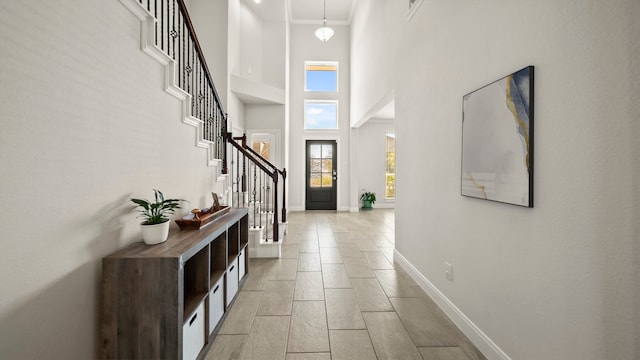 entryway featuring a towering ceiling and light hardwood / wood-style floors