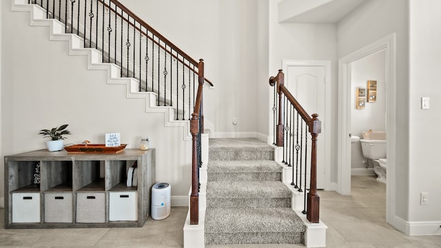 stairs featuring tile patterned flooring