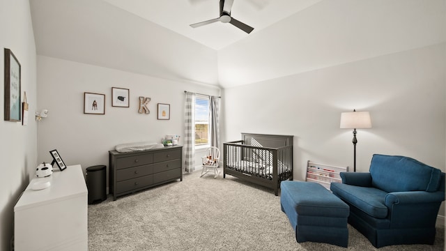 bedroom with a crib, carpet floors, high vaulted ceiling, and ceiling fan