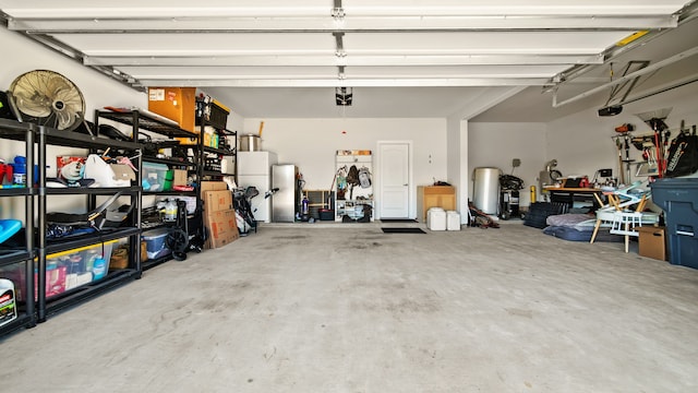 garage with stainless steel refrigerator and a garage door opener