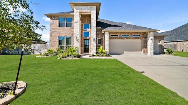 view of front of home with a garage and a front yard