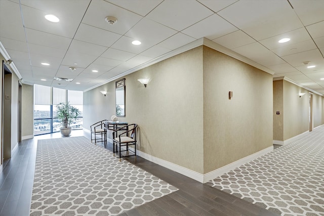 corridor with dark hardwood / wood-style floors and crown molding