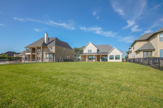 rear view of property with a lawn