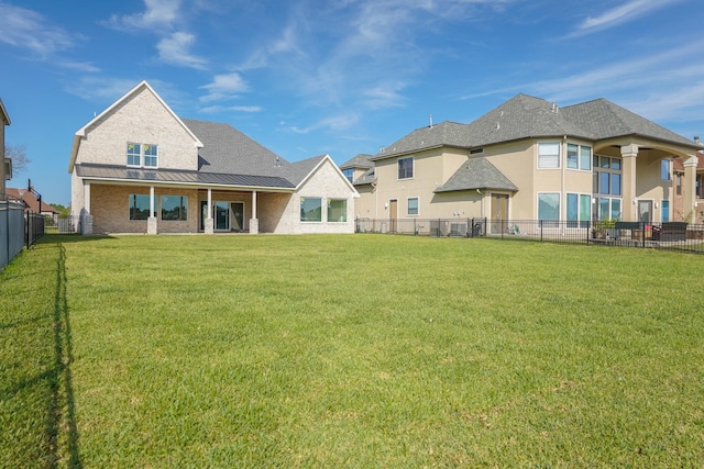 back of house featuring a yard