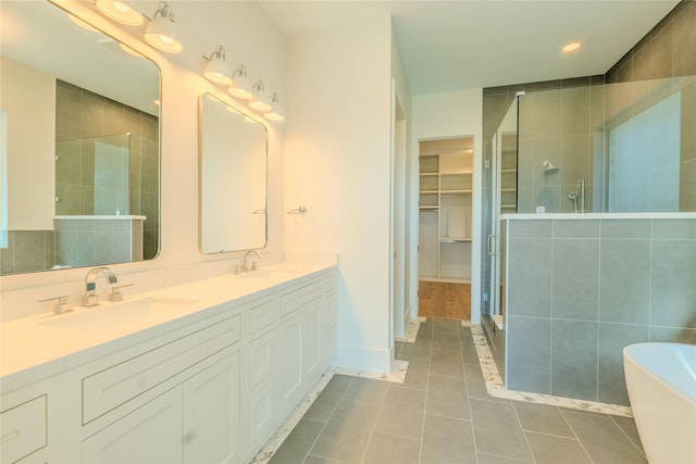 bathroom with vanity, independent shower and bath, and tile patterned floors