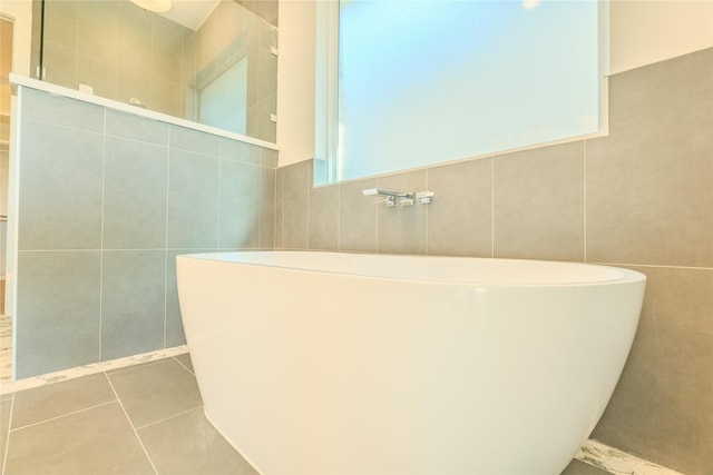 bathroom featuring tile patterned flooring and a tub