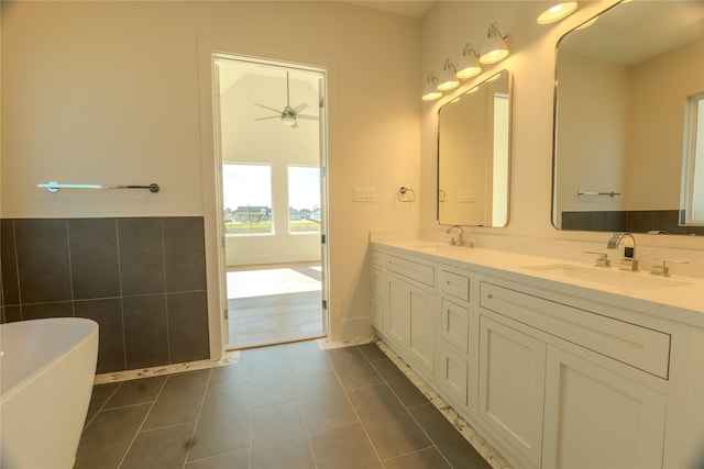 bathroom with a bath, ceiling fan, tile patterned flooring, and vanity