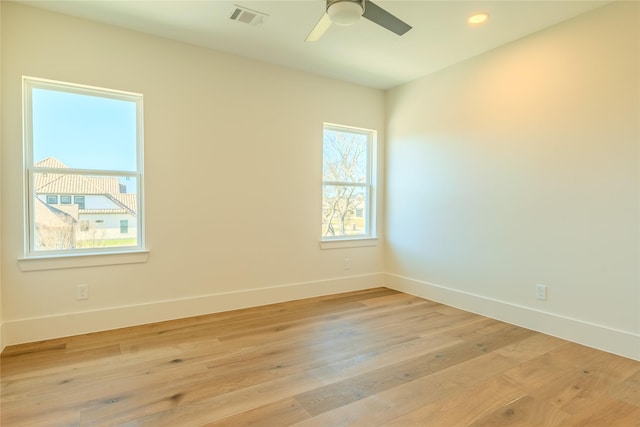 unfurnished room with light wood-type flooring and ceiling fan