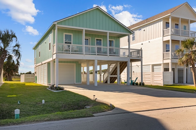 coastal home with a carport, a garage, covered porch, and a front yard