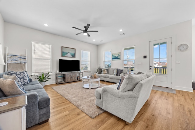 living room featuring ceiling fan and light hardwood / wood-style flooring