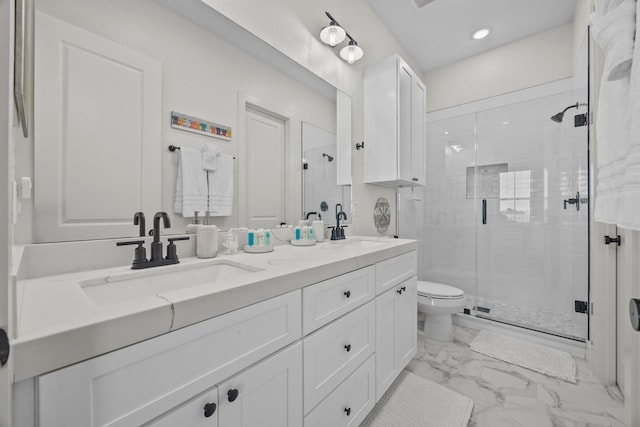 bathroom with vanity, a shower with shower door, and toilet