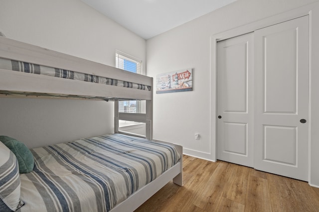 bedroom featuring hardwood / wood-style floors and a closet