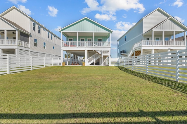 rear view of house featuring a lawn