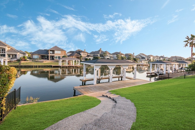 view of dock with a water view and a yard