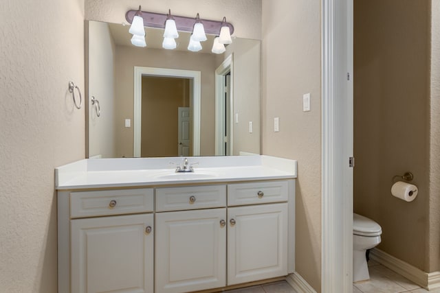 bathroom with tile patterned floors, vanity, and toilet