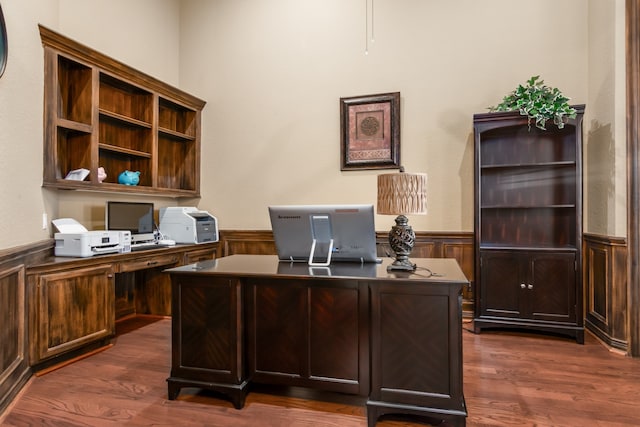 home office featuring built in desk and dark wood-type flooring