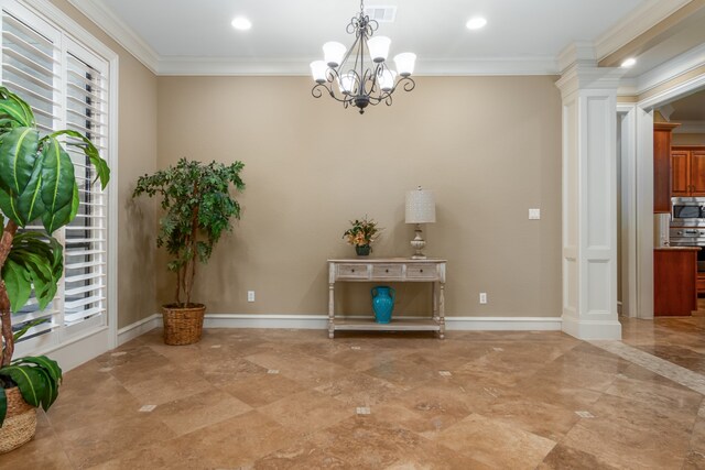 interior space featuring a notable chandelier, ornamental molding, a wealth of natural light, and decorative columns