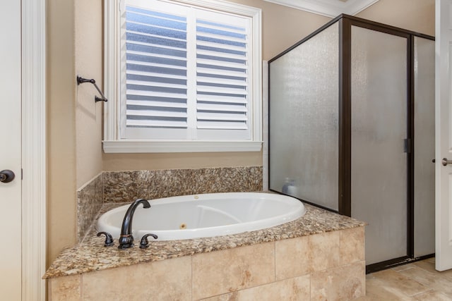 bathroom with ornamental molding and independent shower and bath