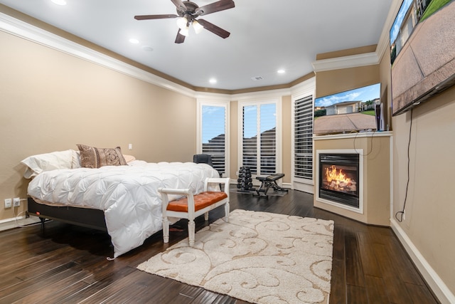 bedroom featuring ceiling fan, crown molding, and dark hardwood / wood-style floors