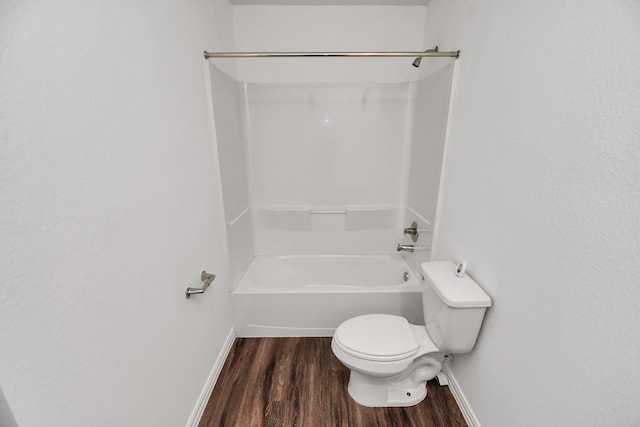 bathroom featuring bathing tub / shower combination, hardwood / wood-style floors, and toilet