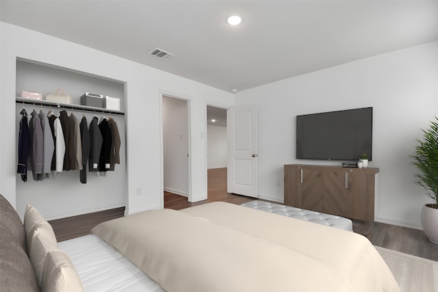 bedroom with a closet and hardwood / wood-style flooring