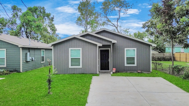 view of front facade with a patio and a front yard