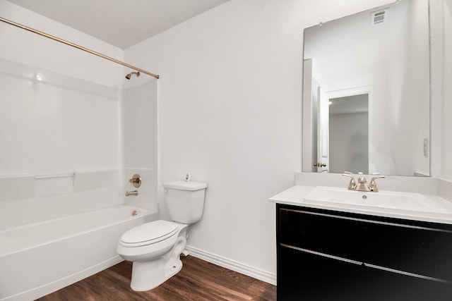 full bathroom with vanity, toilet, washtub / shower combination, and hardwood / wood-style flooring