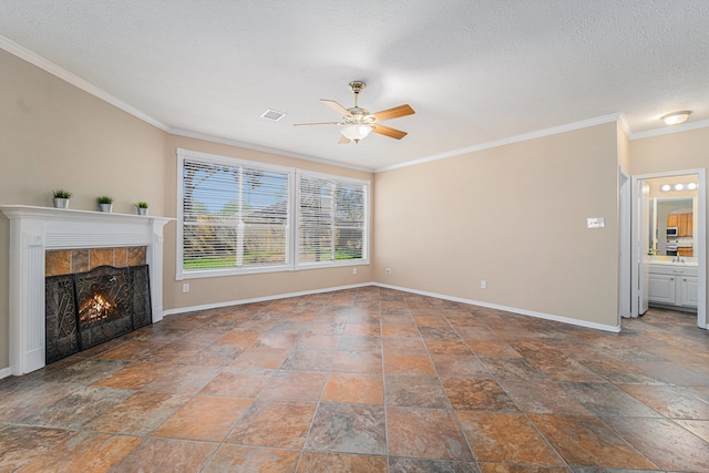 unfurnished living room featuring a textured ceiling, ceiling fan, crown molding, and a tiled fireplace