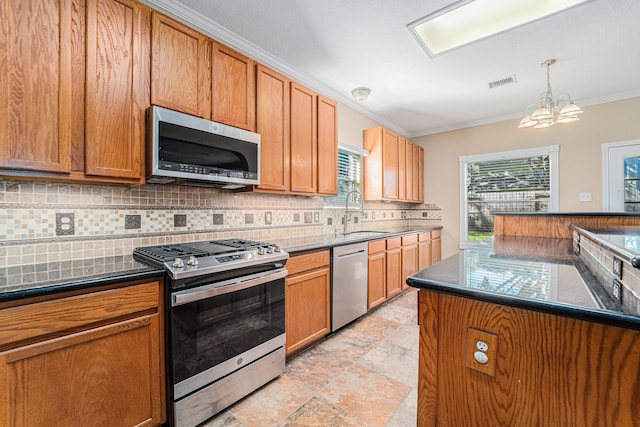 kitchen featuring backsplash, sink, ornamental molding, appliances with stainless steel finishes, and a notable chandelier