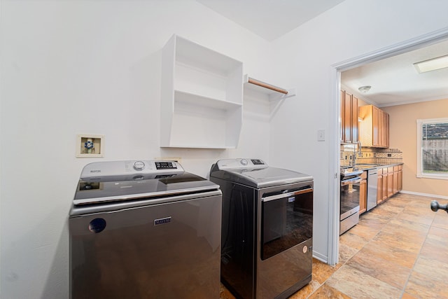 laundry room with washer and clothes dryer and sink