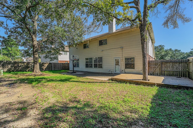 rear view of property with a lawn and a patio area