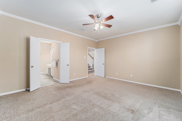 unfurnished bedroom featuring connected bathroom, ceiling fan, light colored carpet, and ornamental molding