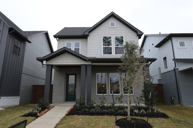 view of front facade with a front lawn and brick siding