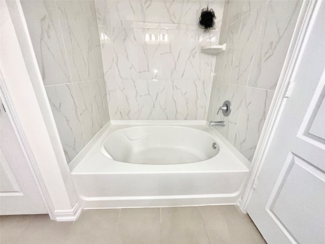 bathroom featuring tile patterned flooring and tiled shower / bath combo