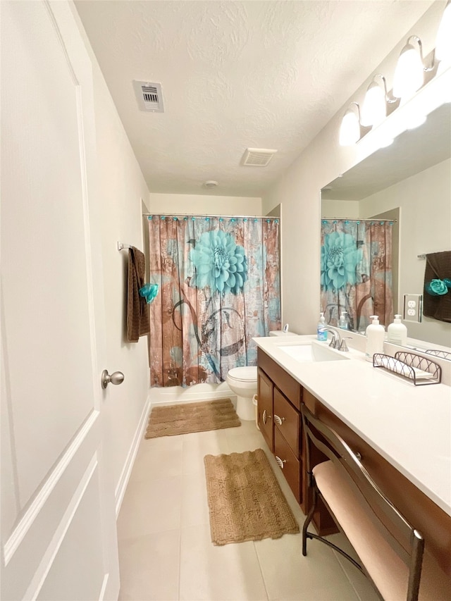 full bathroom featuring vanity, shower / bath combination with curtain, tile patterned flooring, toilet, and a textured ceiling