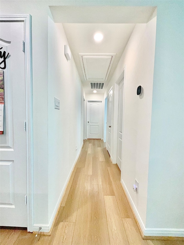 corridor with light wood-type flooring