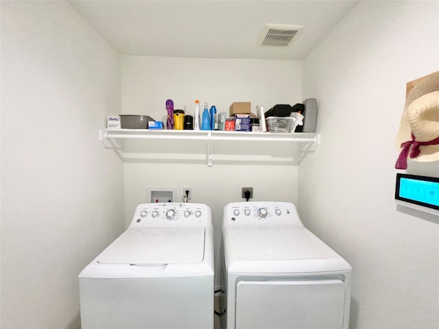 laundry area with independent washer and dryer