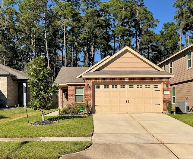 view of front of property featuring a garage, a front yard, and central AC