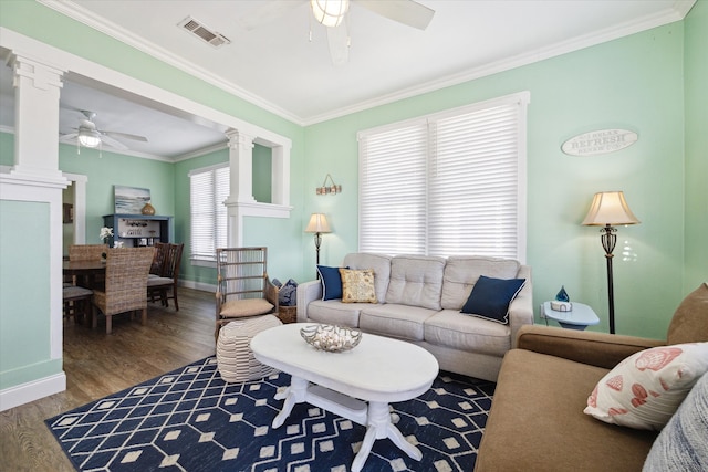 living room with ornate columns, ceiling fan, crown molding, and hardwood / wood-style flooring