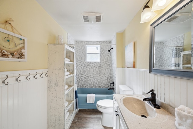 full bathroom with vanity, wood-type flooring, shower / bath combo, and toilet